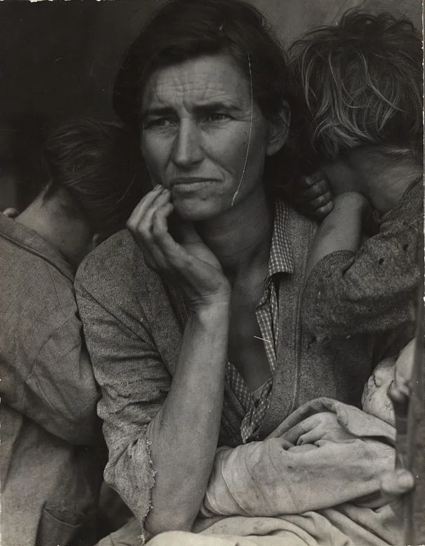 Dorothea Lange’s 1936 photograph of a mother and her children, before restoration — a thin bright scratch running down the mother’s face